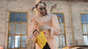 Evil clown animatronic holding doll with violent motion in haunted carnival scene